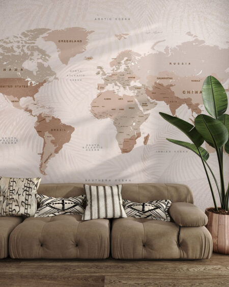 Дизайнерські фотошпалери карта світу в бежевих відтінках на декоративному тлі, прикрашеному тінню листя у вітальні